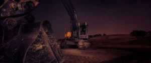 bucket digger on a building site at night with no lighting