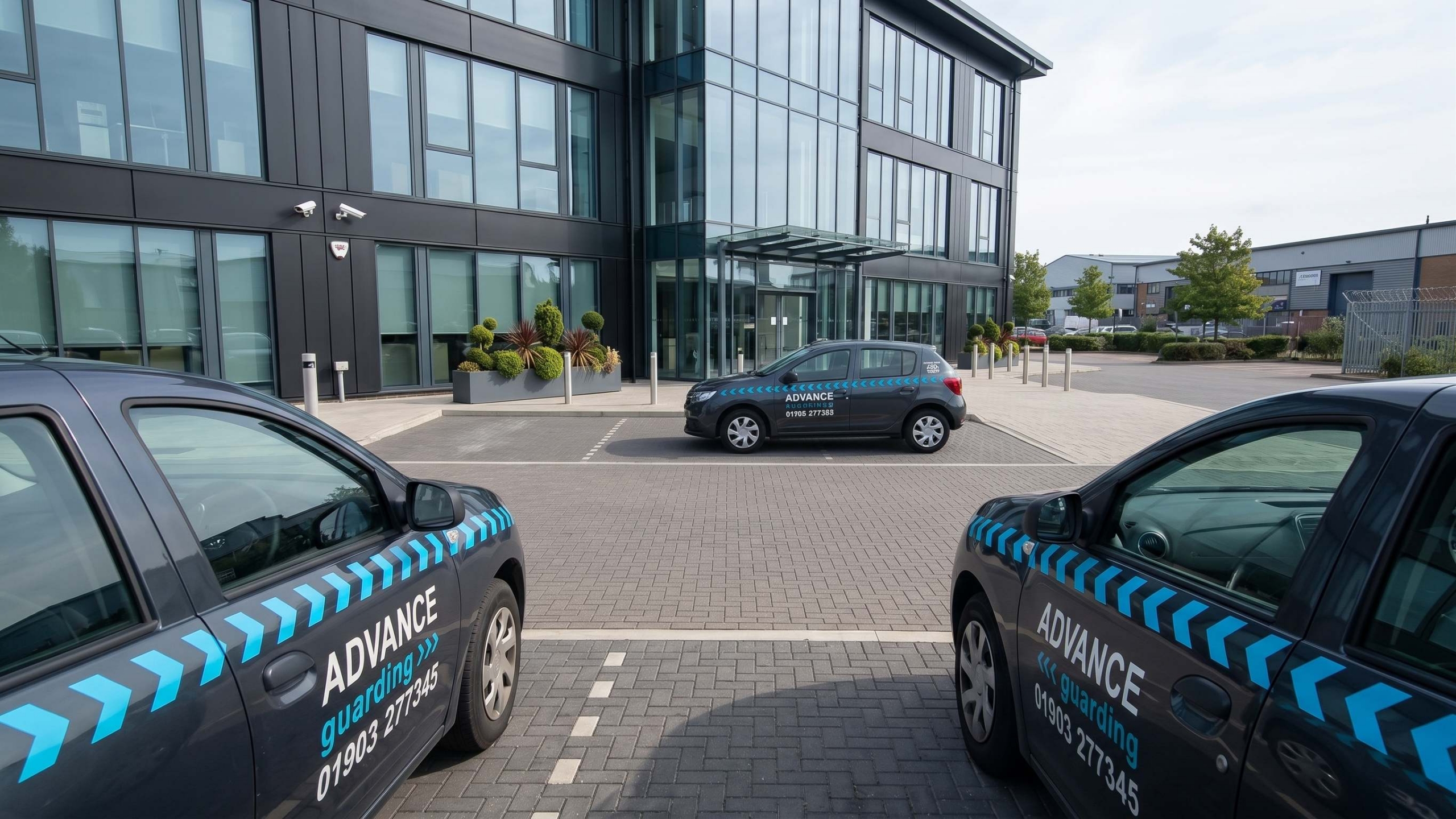 Advance Guarding's main home page image, showing three Advance vehicles in front of an office being patrolled